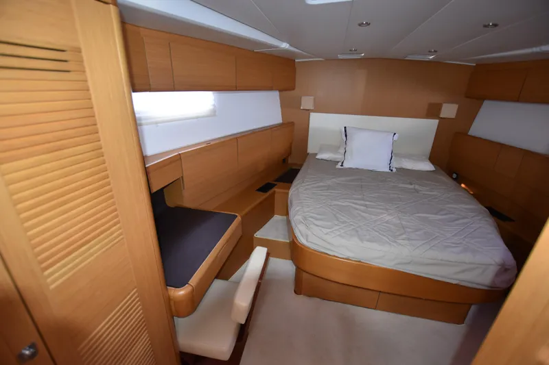 Lady Evelina Yacht Photos Pics Luxurious cabin interior of 2010 Jeanneau 57 yacht with cozy bed and wooden furnishings.
