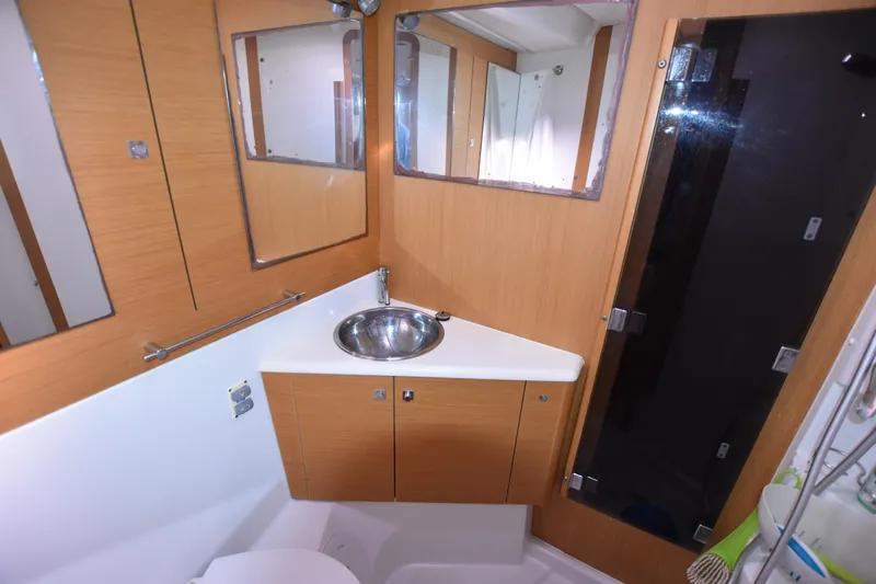 Lady Evelina Yacht Photos Pics Bathroom interior of 2010 Jeanneau 57 yacht with modern fixtures and wooden cabinetry.