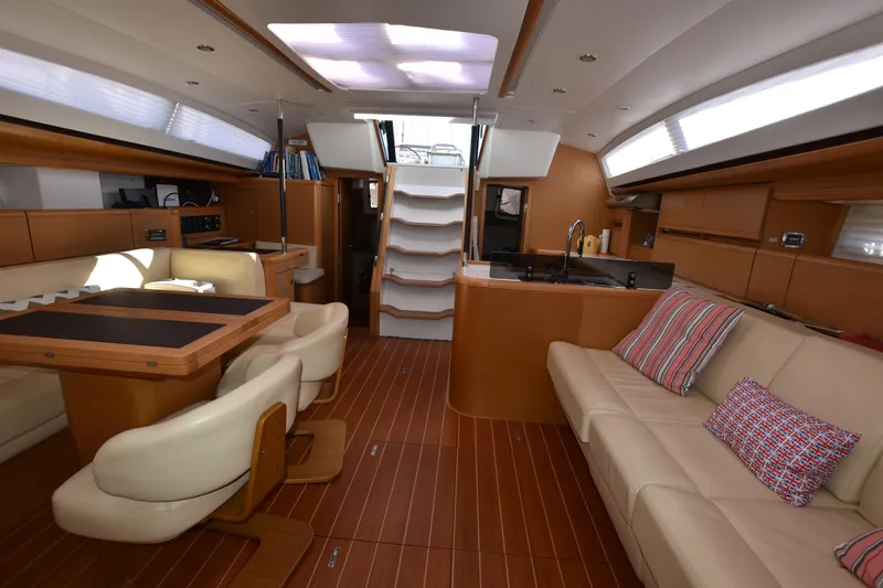 Lady Evelina Yacht Photos Pics Luxurious interior of 2010 Jeanneau 57 yacht with modern seating and wooden flooring.