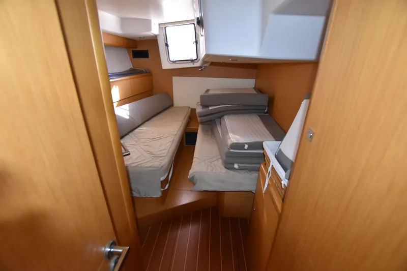 Lady Evelina Yacht Photos Pics Interior cabin of 2010 Jeanneau 57 yacht with twin beds and wooden finish.