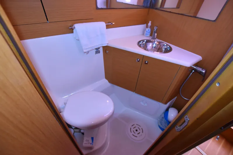 Lady Evelina Yacht Photos Pics Compact bathroom in a 2010 Jeanneau 57 yacht with sink and toilet.