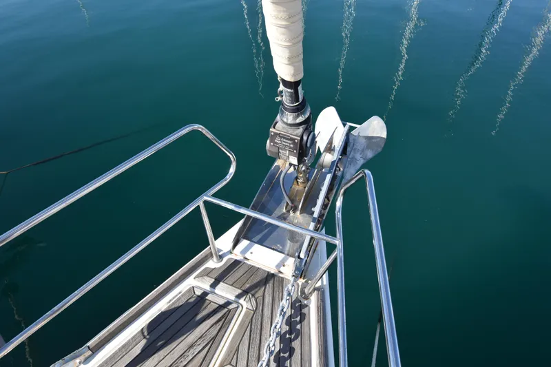 Lady Evelina Yacht Photos Pics Bow of 2010 Jeanneau 57 yacht with anchor and clear water reflection.