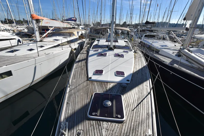 Lady Evelina Yacht Photos Pics 2010 Jeanneau 57 yacht docked in marina, surrounded by other sailboats under clear blue sky.