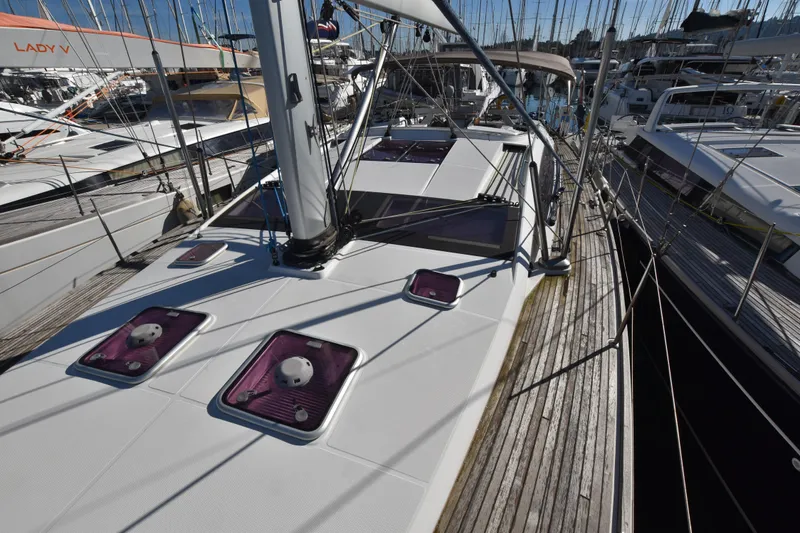 Lady Evelina Yacht Photos Pics 2010 Jeanneau 57 yacht deck with hatches, docked among other sailboats.