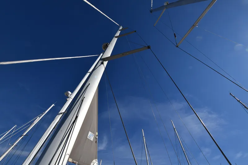 Lady Evelina Yacht Photos Pics Mast and rigging of a 2010 Jeanneau 57 sailboat against a clear blue sky.