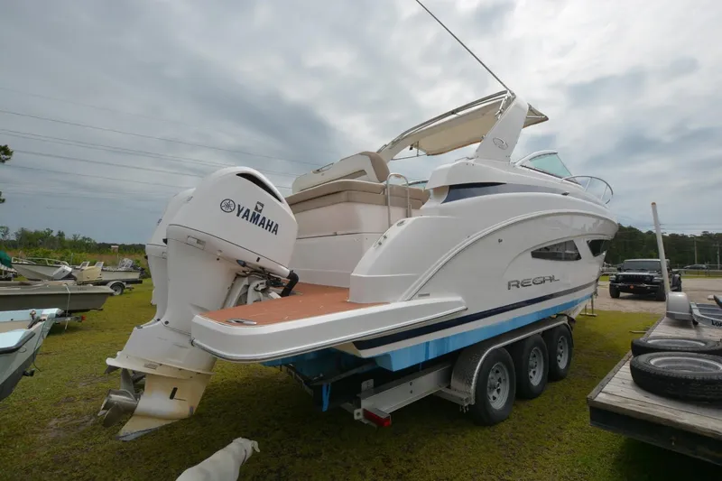 Mountaineer Mayhem Yacht Photos Pics 2018 Regal 33XO boat with Yamaha engine on a trailer, parked outdoors.