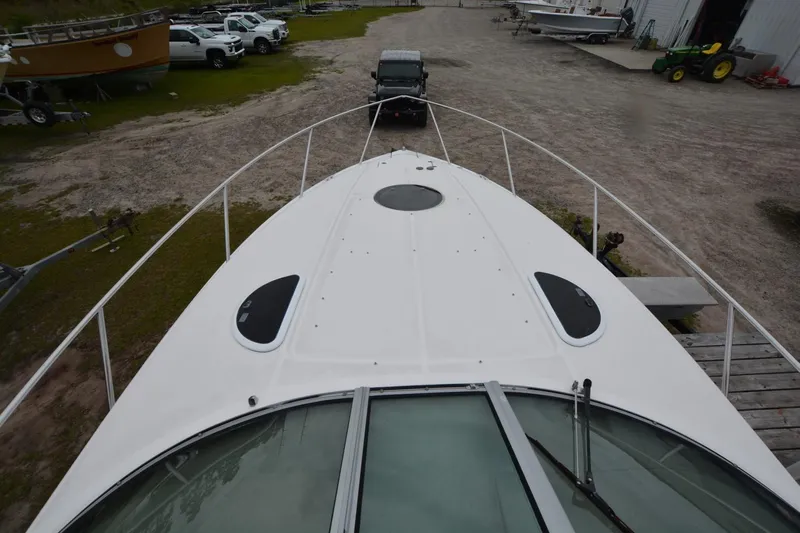 Mountaineer Mayhem Yacht Photos Pics 2018 Regal 33XO boat on trailer, viewed from above, in a yard with vehicles.