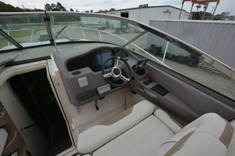 Mountaineer Mayhem Yacht Photos Pics 2018 Regal 33XO boat cockpit with steering wheel and control panel.