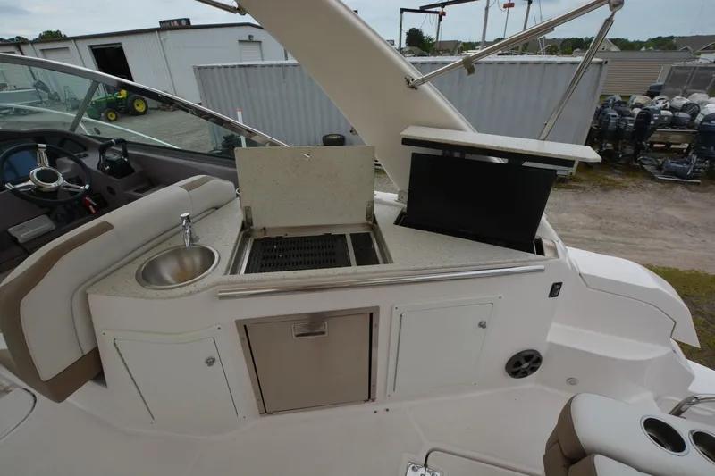 Mountaineer Mayhem Yacht Photos Pics Outdoor kitchen on a 2018 Regal 33XO boat with sink and grill.