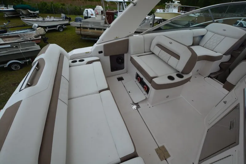 Mountaineer Mayhem Yacht Photos Pics 2018 Regal 33XO boat interior with white and beige seating, cup holders, and spacious layout.