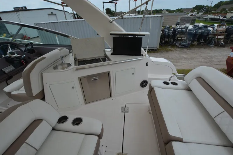 Mountaineer Mayhem Yacht Photos Pics Luxurious 2018 Regal 33XO boat interior with seating, kitchenette, and sink.