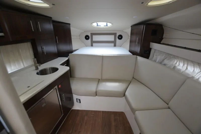 Mountaineer Mayhem Yacht Photos Pics 2018 Regal 33XO yacht interior with kitchenette, seating, and bed. Luxurious and modern design.