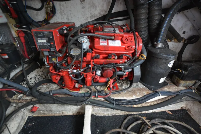 Mountaineer Mayhem Yacht Photos Pics Engine compartment of a 2018 Regal 33XO boat, featuring a red engine and wiring.