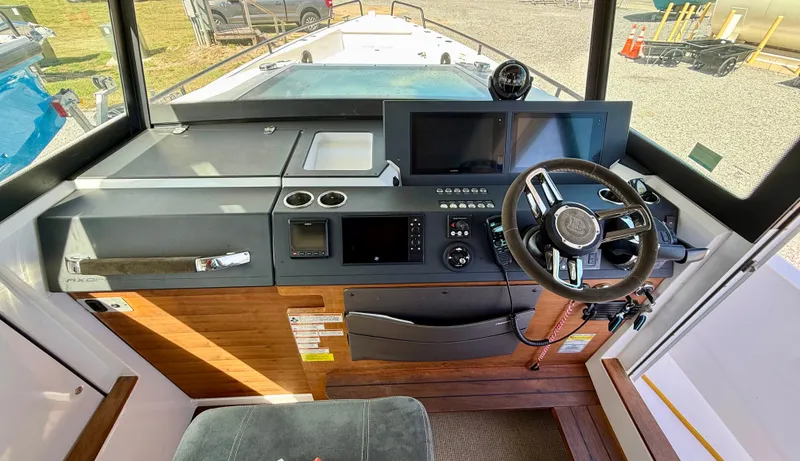 Meraki Yacht Photos Pics 2019 Axopar AX37XC boat cockpit with modern steering and navigation controls.