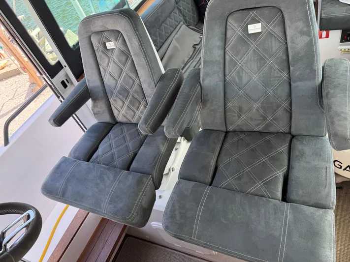 Meraki Yacht Photos Pics Luxurious seating on 2019 Axopar AX37XC boat, featuring plush, diamond-stitched upholstery.