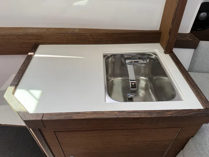Meraki Yacht Photos Pics 2019 Axopar AX37XC boat interior with a sleek stainless steel sink and modern faucet.