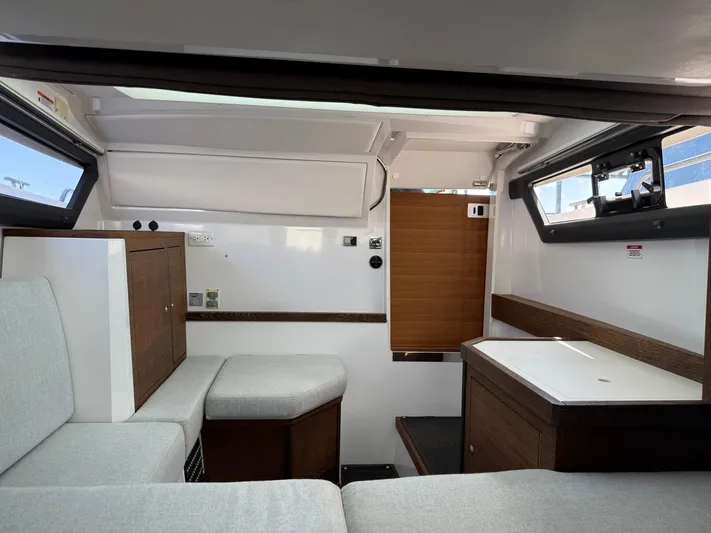 Meraki Yacht Photos Pics Interior of 2019 Axopar AX37XC boat, featuring modern seating and cabinetry.