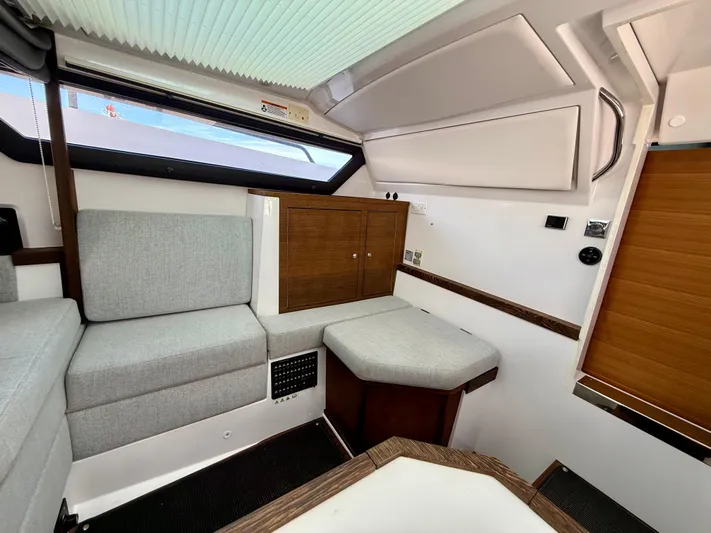 Meraki Yacht Photos Pics 2019 Axopar AX37XC interior with modern seating and wooden cabinetry.