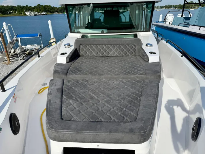 Meraki Yacht Photos Pics 2019 Axopar AX37XC boat with cushioned seating, docked by a serene waterfront.