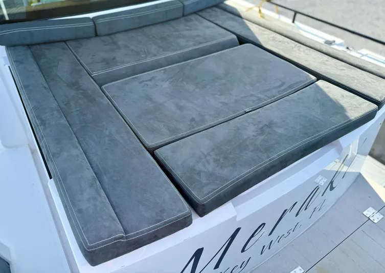 Meraki Yacht Photos Pics Gray cushioned seating on 2019 Axopar AX37XC boat deck.