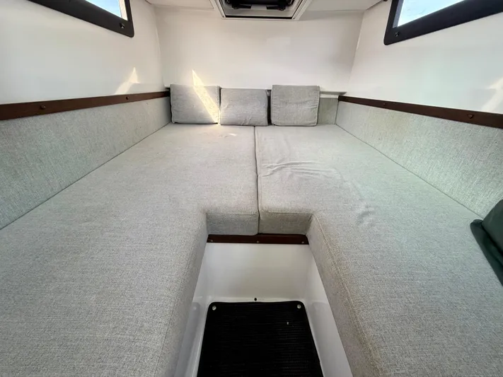 Meraki Yacht Photos Pics Interior cabin of 2019 Axopar AX37XC with gray cushioned seating.