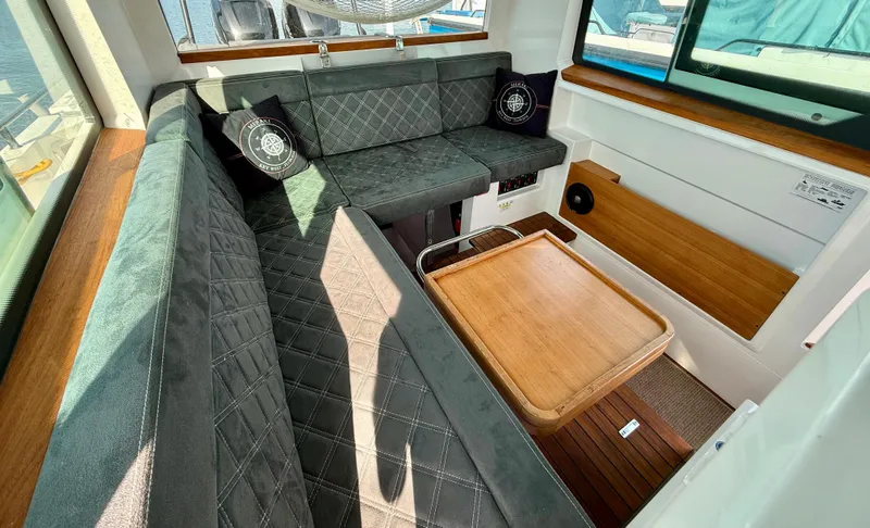 Meraki Yacht Photos Pics Luxurious interior of 2019 Axopar AX37XC boat with plush seating and wooden accents.