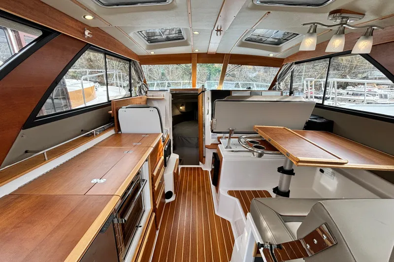  Yacht Photos Pics 2023 Cutwater C-32 Coupe interior with wood finishes and modern amenities.