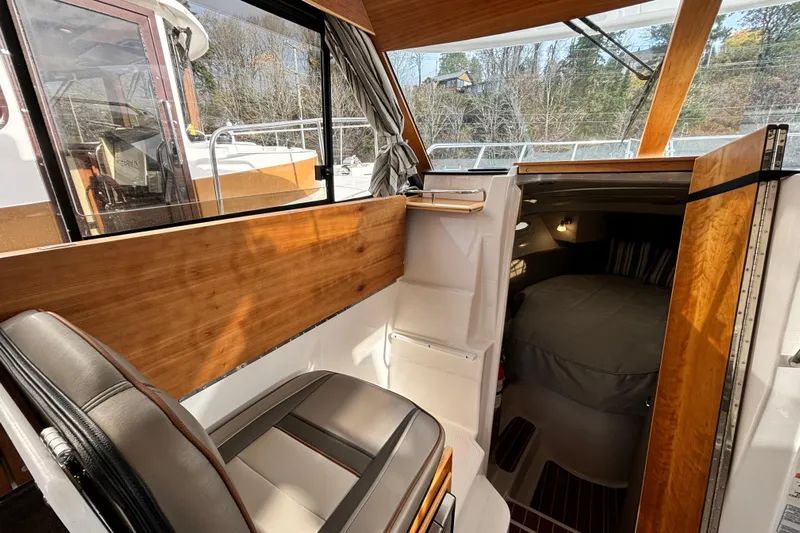  Yacht Photos Pics 2023 Cutwater C-32 Coupe interior with seating and cozy cabin view.