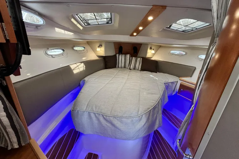  Yacht Photos Pics 2023 Cutwater C-32 Coupe interior cabin with cozy bed and ambient lighting.