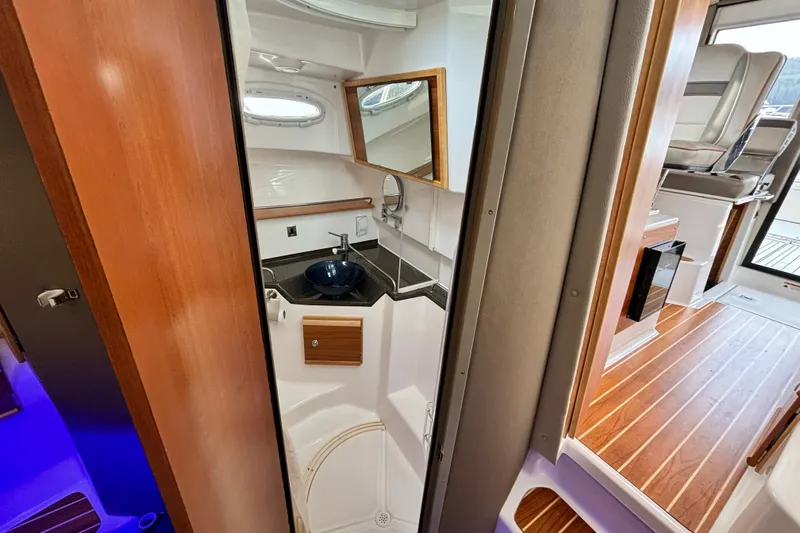  Yacht Photos Pics 2023 Cutwater C-32 Coupe interior with modern bathroom and wooden flooring.