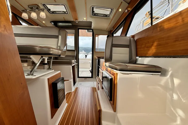  Yacht Photos Pics Interior of 2023 Cutwater C-32 Coupe boat with modern seating and wood accents.