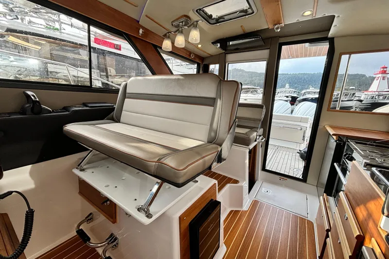  Yacht Photos Pics Interior of 2023 Cutwater C-32 Coupe boat with modern seating and wood flooring.