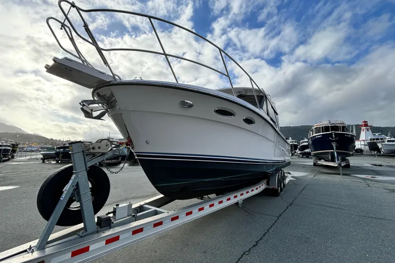  Yacht Photos Pics 2023 Cutwater C-32 Coupe boat on trailer under cloudy sky at marina.