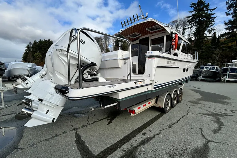  Yacht Photos Pics 2023 Cutwater C-32 Coupe boat on trailer, featuring Yamaha outboard engines.