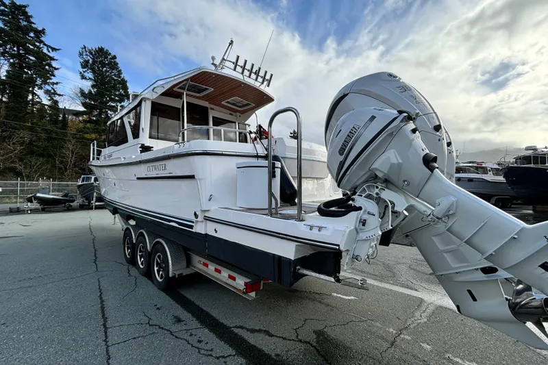  Yacht Photos Pics 2023 Cutwater C-32 Coupe boat on trailer, featuring powerful outboard motor.