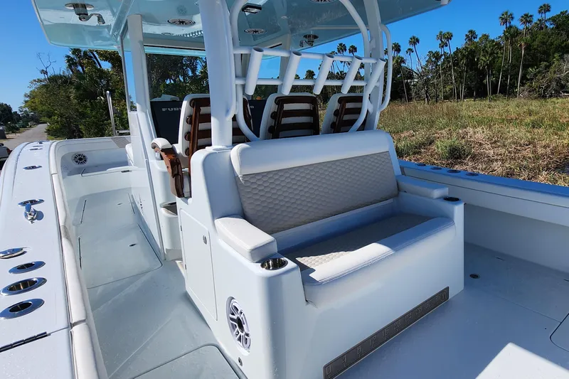 Wanderlust Yacht Photos Pics 2024 Costa Custom Boats 34 SV interior with seating and console, surrounded by lush greenery.