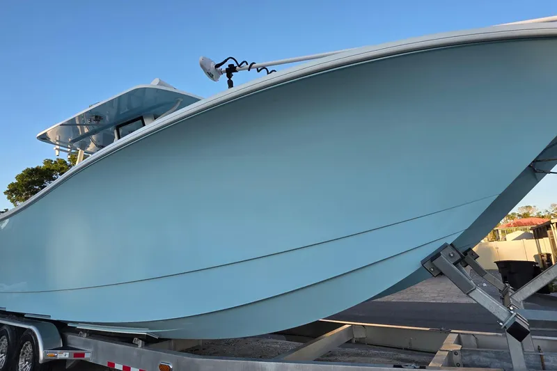 Wanderlust Yacht Photos Pics 2024 Costa Custom Boats 34 SV on trailer, showcasing sleek blue hull design.