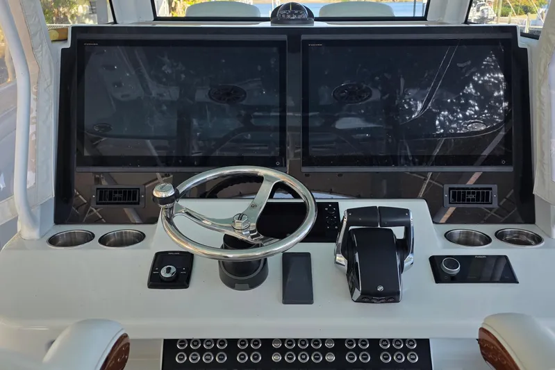 Wanderlust Yacht Photos Pics 2024 Costa Custom Boats 34 SV helm with dual screens and modern controls.