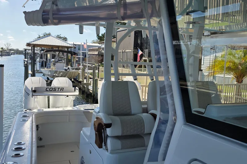 Wanderlust Yacht Photos Pics 2024 Costa Custom Boats 34 SV docked, showcasing sleek design and luxurious seating.