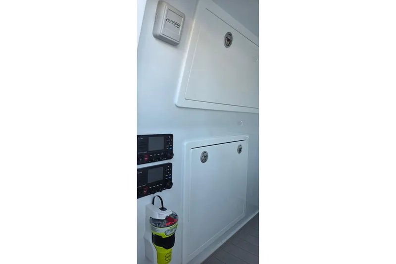 Wanderlust Yacht Photos Pics Interior view of 2024 Costa Custom Boats 34 SV, featuring control panels and storage compartments.