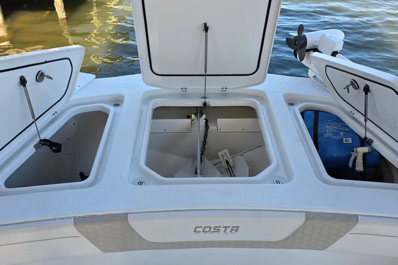 Wanderlust Yacht Photos Pics 2024 Costa Custom Boats 34 SV storage compartments open on deck by the water.