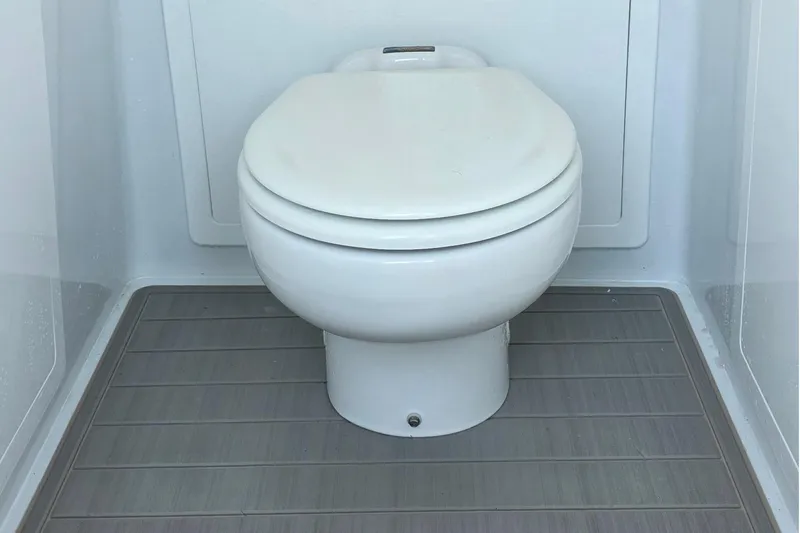 Wanderlust Yacht Photos Pics 2024 Costa Custom Boats 34 SV interior toilet with modern design and wooden flooring.