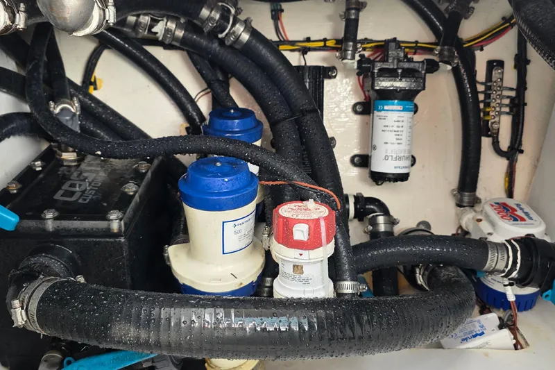 Wanderlust Yacht Photos Pics Engine compartment of 2024 Costa Custom Boats 34 SV, showcasing hoses and components.