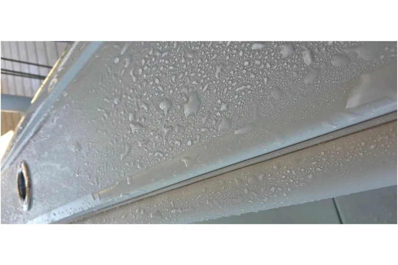 Wanderlust Yacht Photos Pics 2024 Costa Custom Boats 34 SV hull with water droplets, showcasing sleek design.