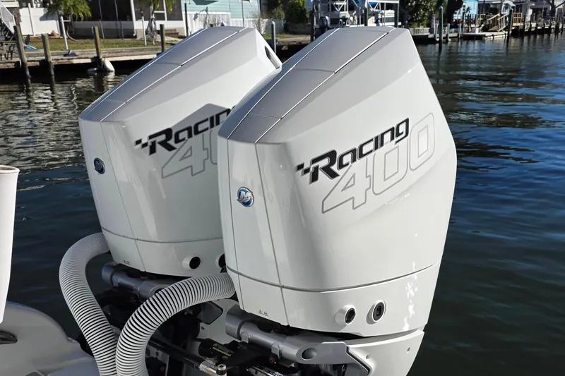 Wanderlust Yacht Photos Pics Twin Mercury Racing 400 engines on 2024 Costa Custom Boats 34 SV, docked by the water.