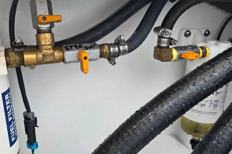 Wanderlust Yacht Photos Pics Fuel system components in a 2024 Costa Custom Boats 34 SV, featuring hoses and valves.