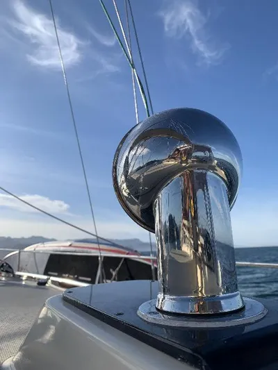  Yacht Photos Pics Close-up of a 1999 Island Packet 380 sailboat's polished metal fitting under a clear sky.