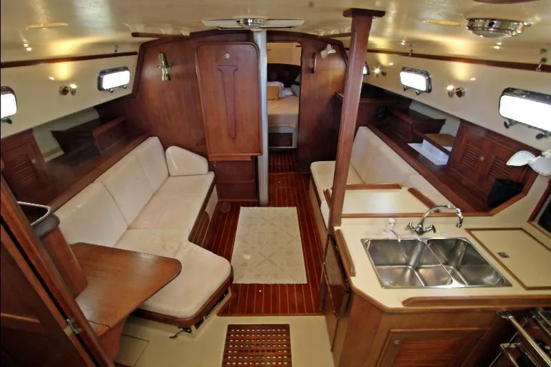  Yacht Photos Pics Interior of 1999 Island Packet 380 sailboat with wood finish and cozy seating.