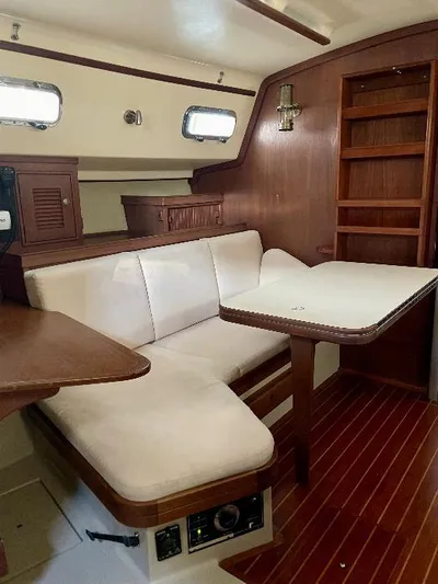  Yacht Photos Pics 1999 Island Packet 380 interior with wooden finish, cushioned seating, and dining table.