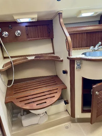  Yacht Photos Pics 1999 Island Packet 380 yacht bathroom with wooden accents and compact design.